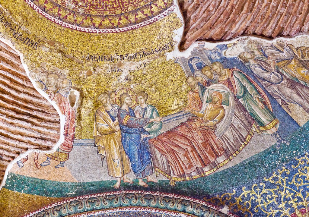 A detailed mosaic depicting a biblical scene with figures, including two central characters, a seated woman, and several other figures around them, set against a textured background.